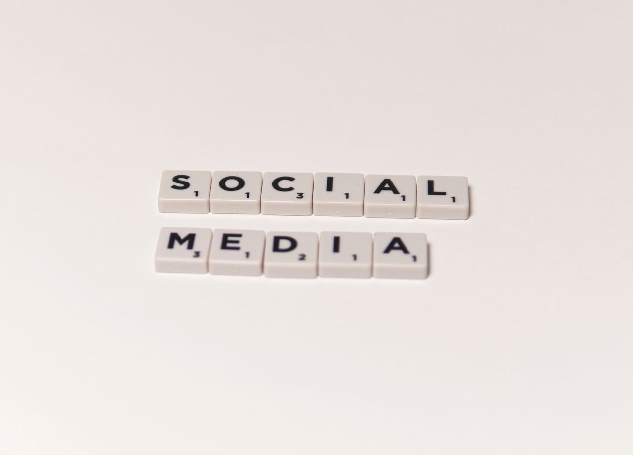 Scrabble tiles spelling social media on a white background, representing digital communication concepts.